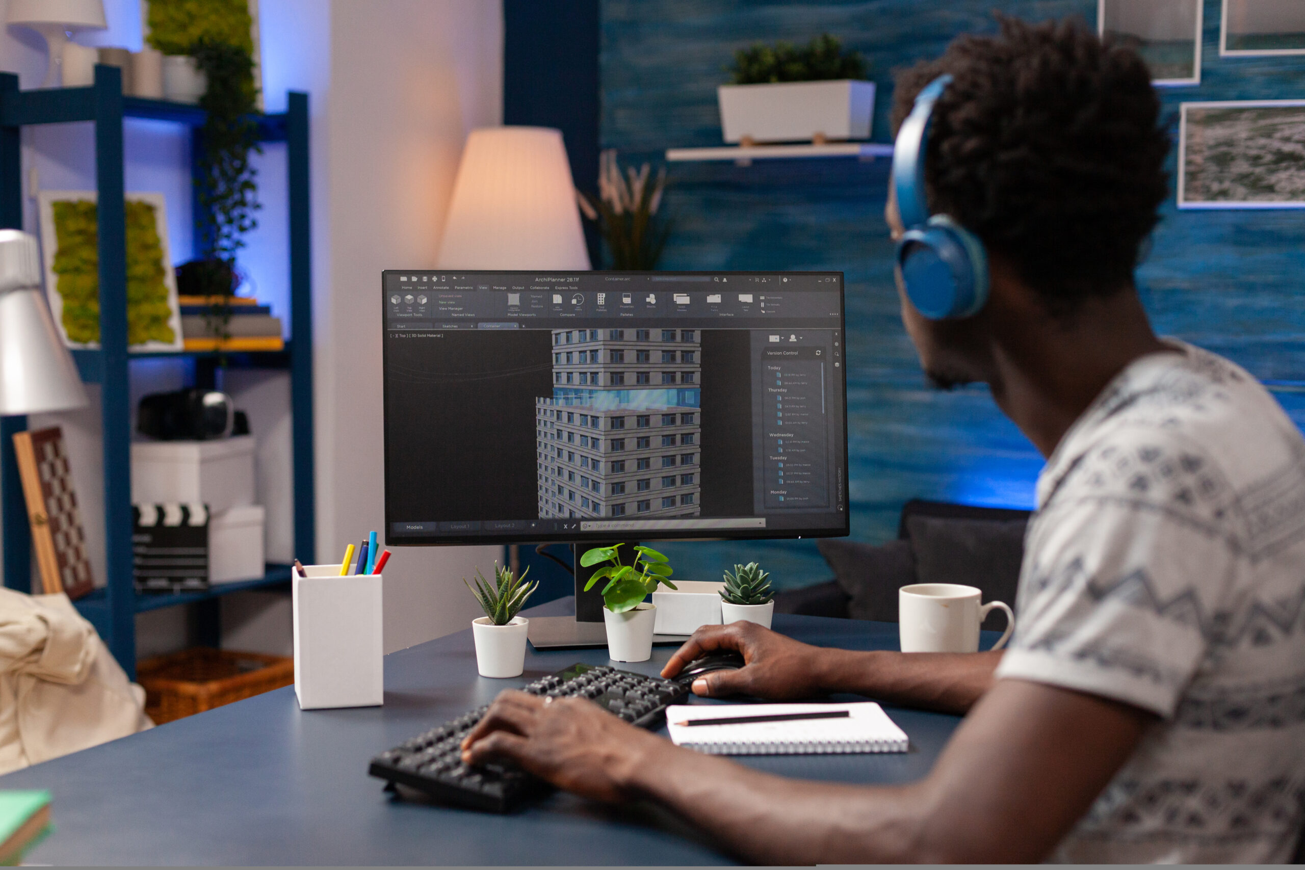 African american architect man analyzing corporate building plan on computer African american architect man analyzing corporate building plan on computer developing urban sketch for skyscraper construction. Young engineer working remote from home using architecture technology